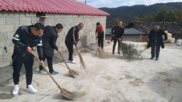 组织参加活动的统战代表人士清扫村内环境卫生
